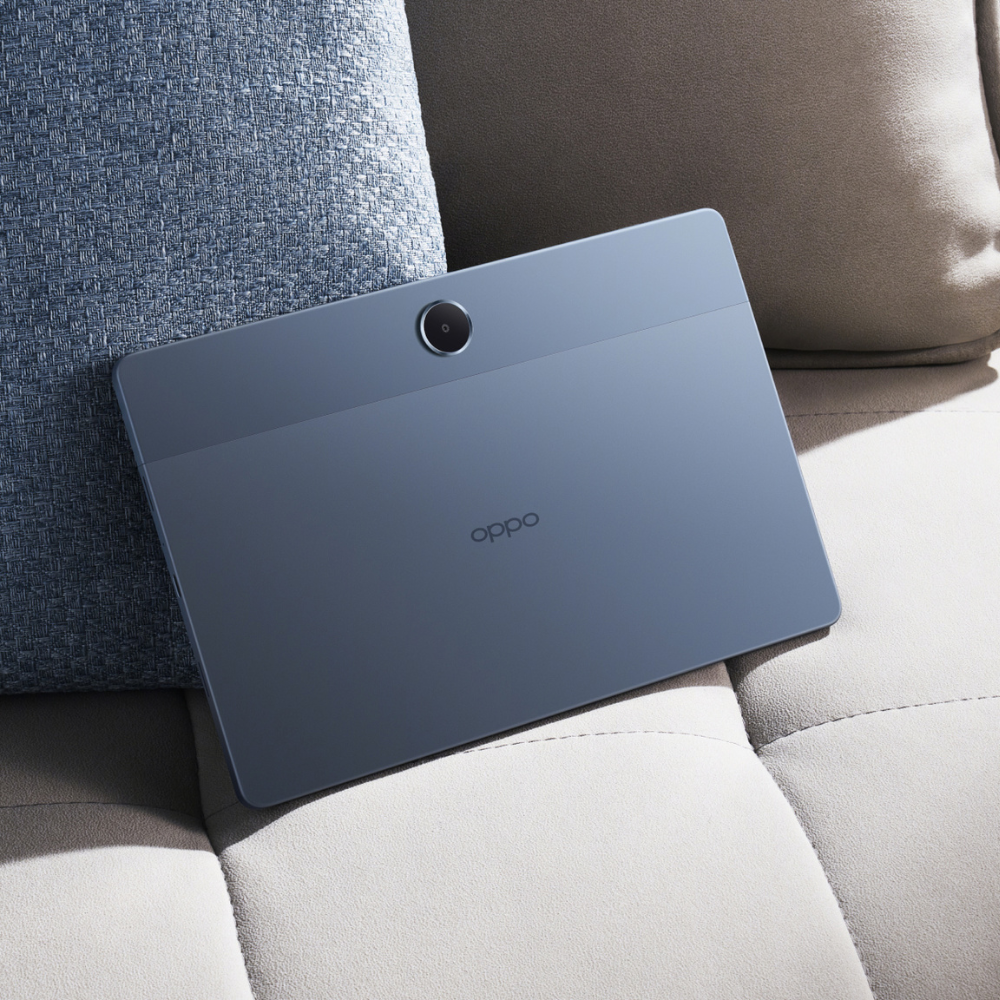 Oppo tablet on a gray surface with cushions in the background